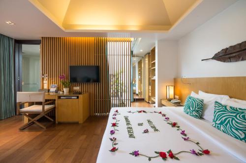 a bedroom with a bed with flowers on it at Chaweng Regent Beach Resort in Chaweng