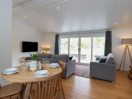 a living room with a table and a couch at Hawthorn Croft in Ulverston
