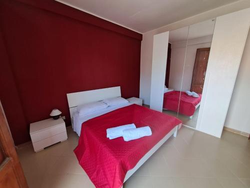 una camera con un letto con una parete rossa di Villa Paola a Capaci