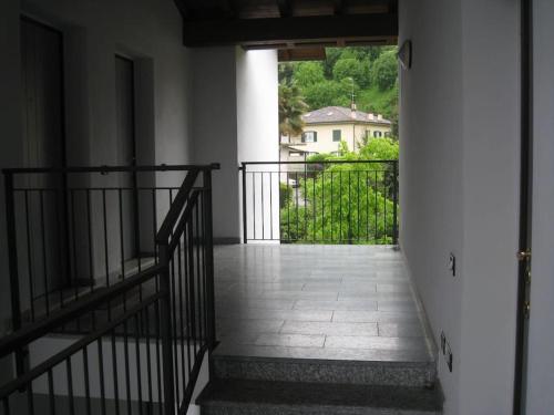 an empty hallway with a balcony with a gate at Franca’s dream - Bellagio in Bellagio