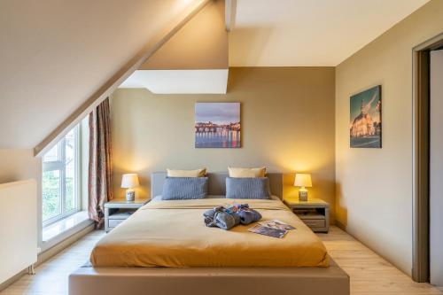 a bedroom with a large bed with two night stands at Maas&Mechelen B&B Massage & Wellness in Maasmechelen