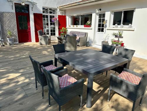 a wooden table and chairs on a patio at La Maison Florence in Mont-de-Marsan