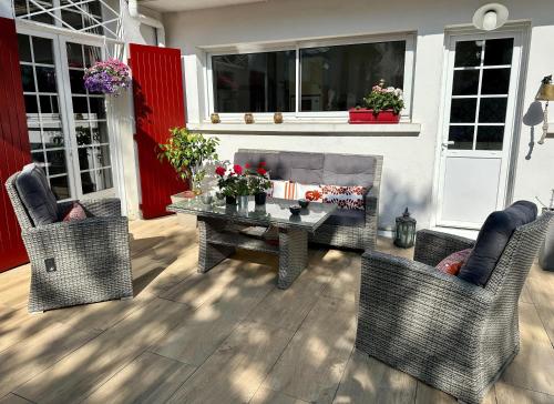 a patio with a table and two chairs at La Maison Florence in Mont-de-Marsan