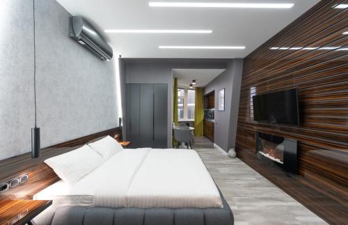 a bedroom with a bed and a flat screen tv at Luxury Apartments Arena Guliver in Kyiv