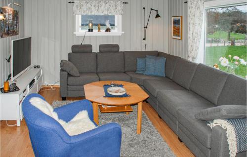 a living room with a couch and a table at 3 Bedroom Awesome Home In Skjold in Skjold