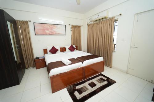 a bedroom with a large bed in a room at The Altruist Business Stays Bellandur-1 in Bengaluru