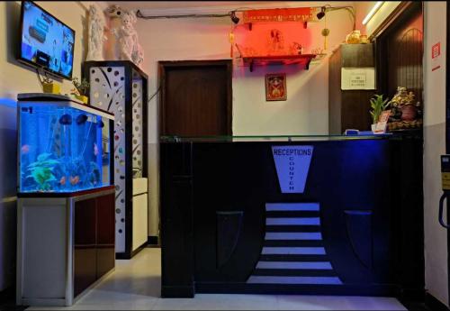 a staircase leading to a room with a fish tank at OYO Royal Inn Near Lotus Temple in New Delhi