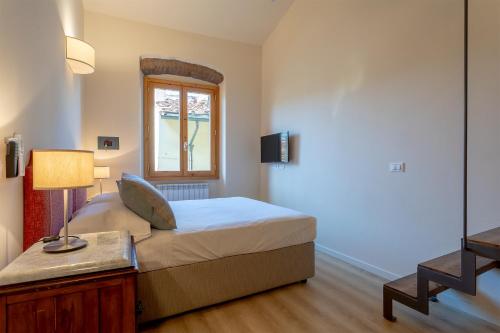a bedroom with a bed and a window at Ramaglianti Apartments Suite Tre in Florence