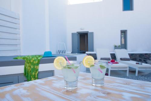 two cocktails sitting on a table on a patio at LAGADI SUITES by K&K in Mesaria