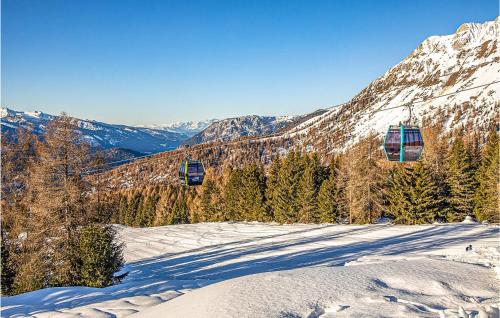 a ski lift going up a snow covered mountain at Chalet Luisa in Predazzo