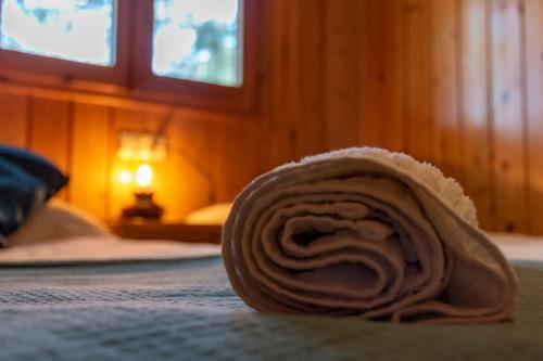 a roll of cloth laying on a bed at Las Casitas del Pinar in Bayubas de Abajo