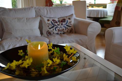 a candle and flowers on a coffee table in a living room at Appartementhaus Astl in Sankt Johann in Tirol