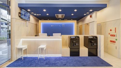 a store with two checkout counters and two stools at Toyoko Inn Osaka Bentencho in Osaka