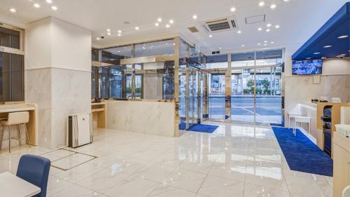 a lobby of a building with glass walls at Toyoko Inn Osaka Bentencho in Osaka