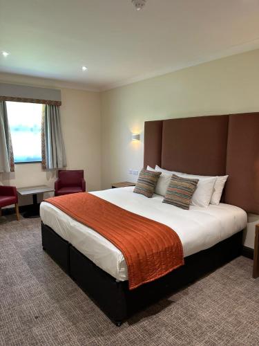 a bedroom with a large bed in a hotel room at Dragonfly Hotel King's Lynn in Kings Lynn