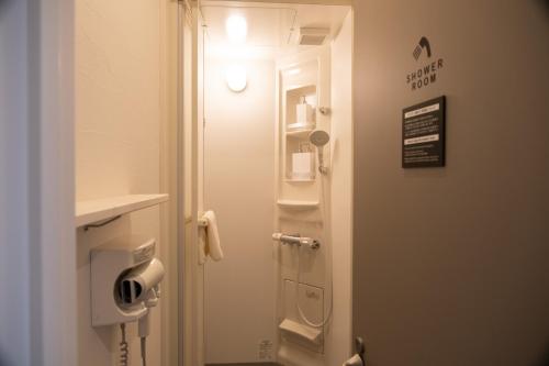 a bathroom with a toilet with a sign on the door at HOTEL BOTH in Shari