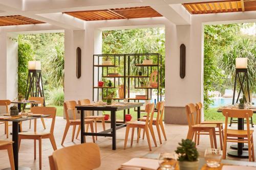 a restaurant with tables and chairs and windows at Hyatt Regency Casablanca in Casablanca