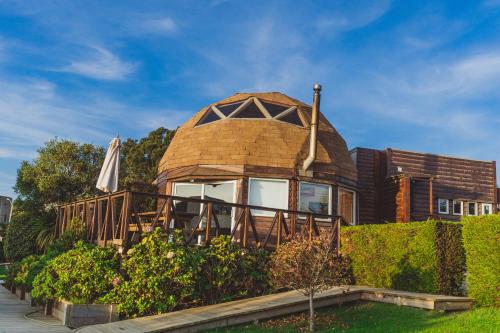 a house with a dome roof and a deck at Pichilemu Domos in Pichilemu