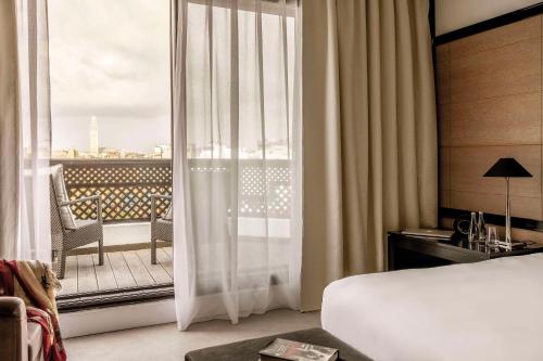 a bedroom with a bed and a window with a balcony at Hyatt Regency Casablanca in Casablanca