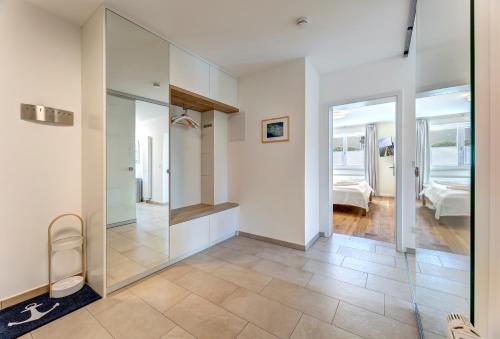 a bathroom with a glass shower and a bedroom at Villa Madeleine App. 2 in Heringsdorf