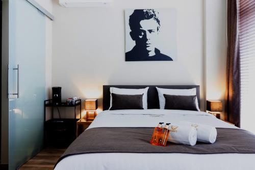 a bedroom with a bed with two bags on it at JT HOMES in Bruges