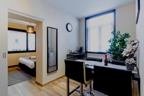 a room with a desk and a bedroom with a bed at JT HOMES in Bruges