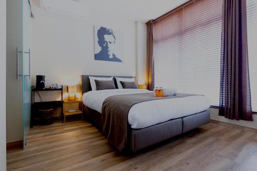 a bedroom with a large bed and a window at JT HOMES in Bruges