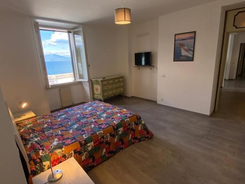 a bedroom with a bed and a window at Wonderful Stresa apartment in Stresa