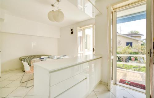 a white kitchen with a table and a window at Villa Maria in Calendasco