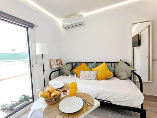 a bedroom with a bed with a table with fruit on it at Lovely Terrace Apart. Downtown in Faro