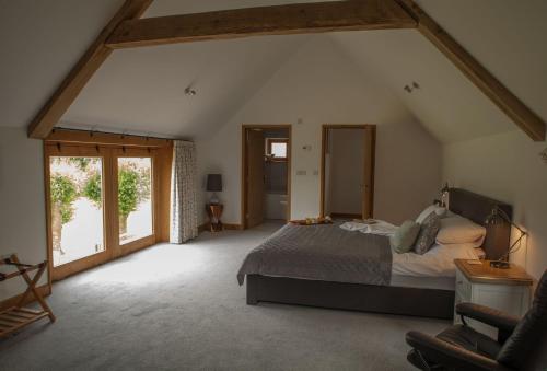 a bedroom with a large bed in a attic at Goose Run Cottage in Corscombe