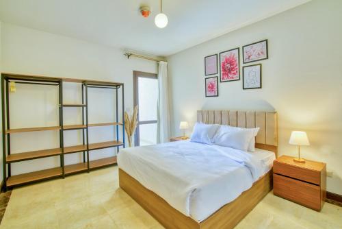 a bedroom with a large bed with white sheets at LOFTS by Elegant Hospitality in Cairo