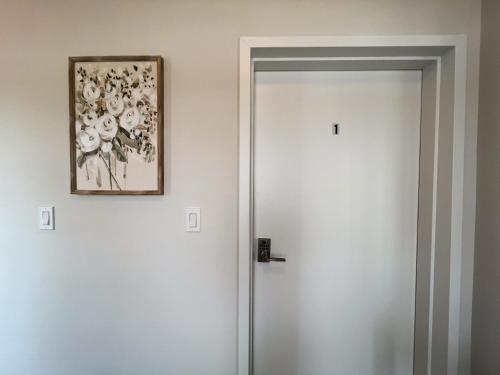 a picture hanging on a wall next to a door at GLOBALSTAY New houses near Huron Lake in Port Elgin