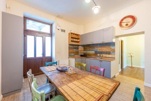 a kitchen with a wooden table and chairs at CozyFlat in the central Arad in Arad