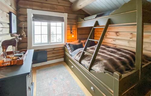 a bedroom with a bed in a log cabin at Amazing Home In Rauland With Wifi in Rauland