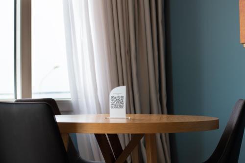 a table with a sign on it next to a window at Heliotrope Hotels in Mytilini