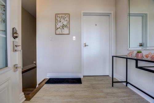 a hallway with a white door and a table at GLOBALSTAY New houses near Huron Lake in Port Elgin