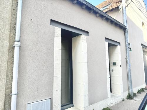 a building with two large windows on the side of it at Le Patio de Loiseau in Le Mans
