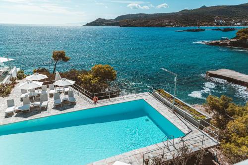 a swimming pool with a view of the ocean at Apollo Resort in Agia Marina Aegina