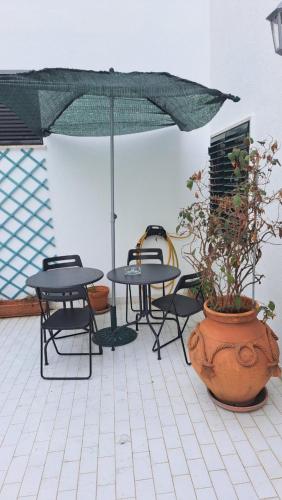 a patio with tables and chairs and an umbrella at Tejo Apartment in Lisbon