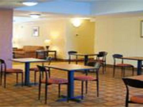 a room with tables and chairs in a room at Days Inn by Wyndham Semmes Mobile in Mobile