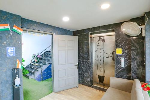 a room with a door with a painting on the wall at FabExpress Blusky in New Delhi