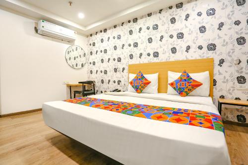 a bedroom with a large bed and a wall with skulls at FabExpress Blusky in New Delhi