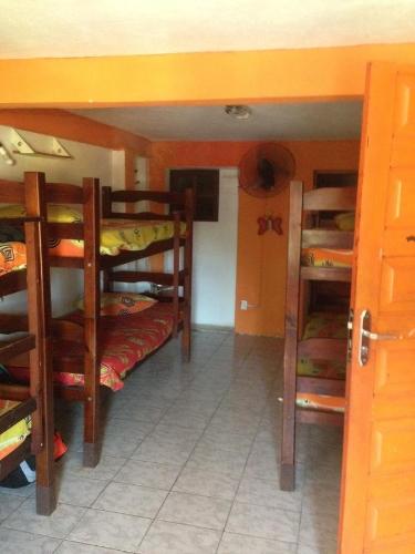 a room with several bunk beds in a room at Nega Maluca Guesthouse in Salvador