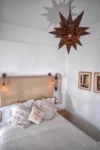 a bedroom with a large bed and a chandelier at Affittacamere Capri Dolce Vita in Capri