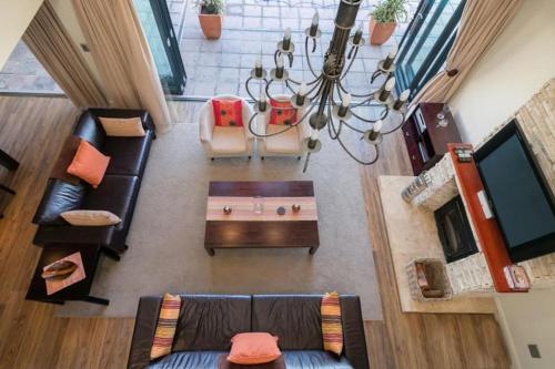 an overhead view of a living room with furniture and a chandelier at SW2 - Pezula Luxury Villa in Knysna