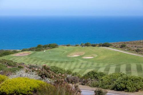 an aerial view of a golf course with the ocean in the background at SW2 - Pezula Luxury Villa in Knysna