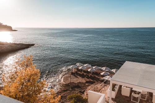 an aerial view of a beach with chairs and the ocean at Apollo Resort in Agia Marina Aegina