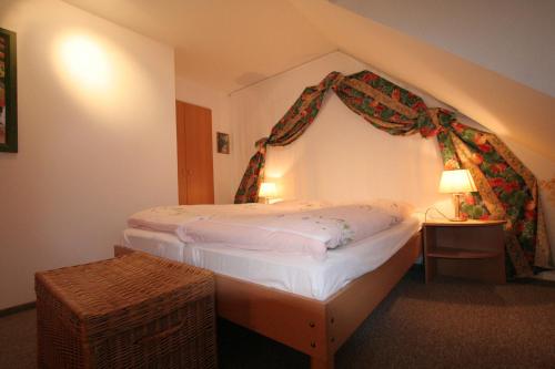 a bedroom with a bed with a canopy at Glaeßer Appartements in Burg auf Fehmarn