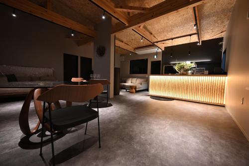 een kamer met een tafel en stoelen en een bank bij GRAN TOCORO. RESORT&GLAMPING in Narusawa
